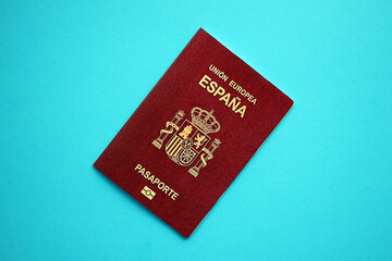 Red Spanish passport of European Union on blue background close up. Tourism and citizenship concept - obrazy, fototapety, plakaty