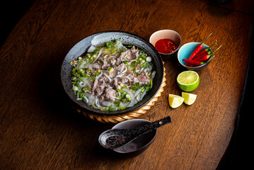 Asian beef soup in a black ceramic plate