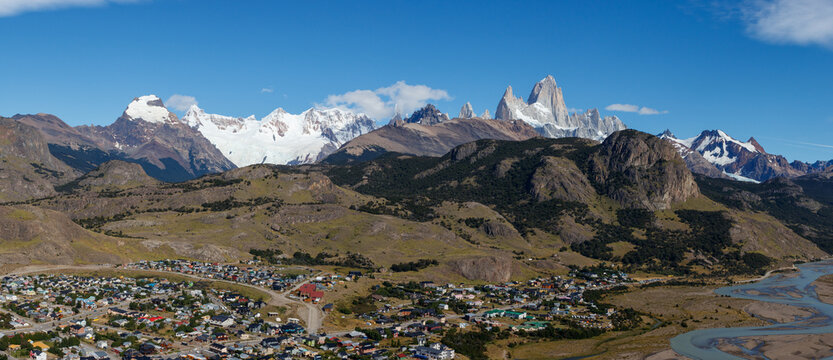 El Chalten village with panorama of mountain range Fitz Roy on a sunny day with blue sky. It is a mountain in Patagonia, on the border between Argentina and Chile