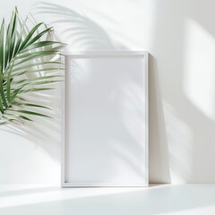a white wood thin picture frame with white paper inside leaning up against a white wall and white surface