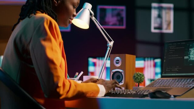 African american system engineer using AI system to write computer program code, html terminal window. Woman works with deep learning algorithms, artificial intelligence neural networks. Camera A.