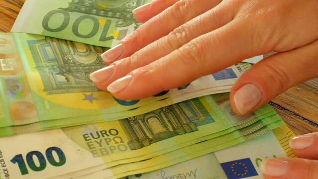 One hundred euro banknotes in hands.Cash payments in EU countries .Hands counting out euro money on the table. 4k footage