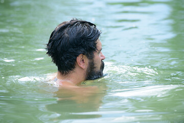 Man swimming in water. Swimmer swim concept. Summer time lake.