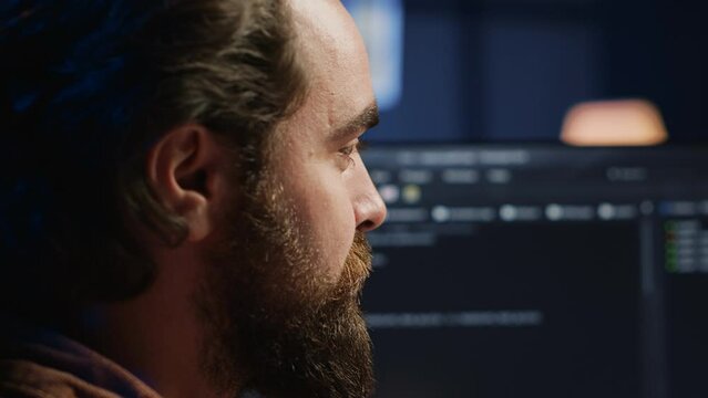 Happy software engineer feeling satisfied after removing all bugs while coding on computer, close up. Joyous IT admin looking at PC screen, pleased after solving script errors, camera A close up