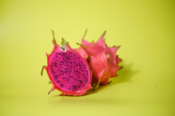 Fresh red dragon fruit or pitaya ready to eat on yellow background, tropical fruit 