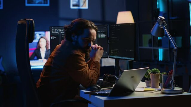 Developer typing code in home office, using Java programming language to develop software application. It professional using multimonitor PC setup and laptop to finish tasks, camera A