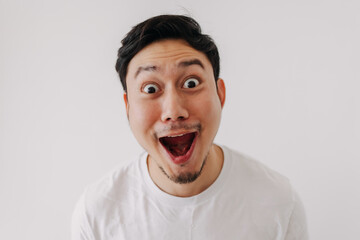 Happy funny big smile face of Asian man wears white t-shirt portrait isolated on white background.