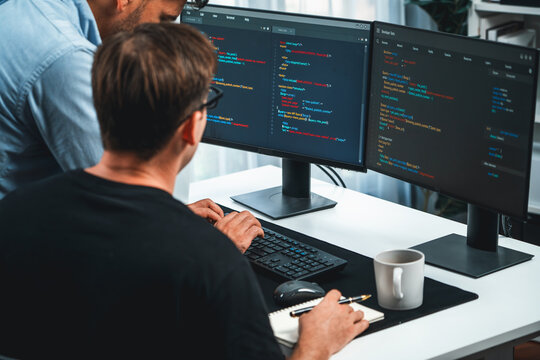 IT developers discussing online software development information on pc screen, creating program coding for latest version application on website. Concept of brainstorming firmware updated. Sellable.