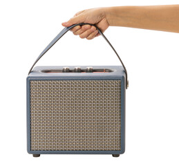 Hand holding Retro style Bluetooth speaker with volume knob and strong grille, ready to hold...
