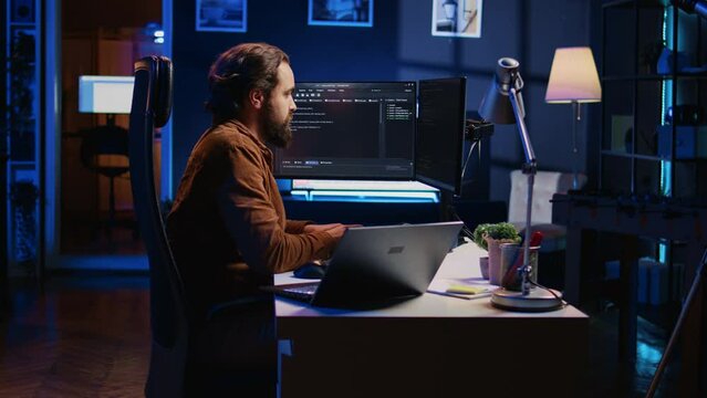 Overworked developer complaining while typing difficult code in home office, developing software application. IT expert groaning while solving coding project tasks, suffering from burnout, camera B
