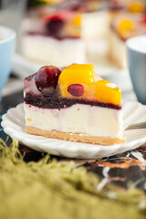 Delicious and light no-bake cheesecake with summer fruits including strawberry, mango, and grapes.