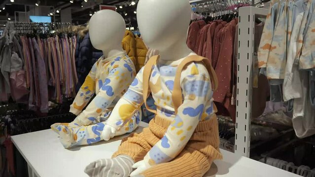 Mannequins in children's clothing in a clothing store.