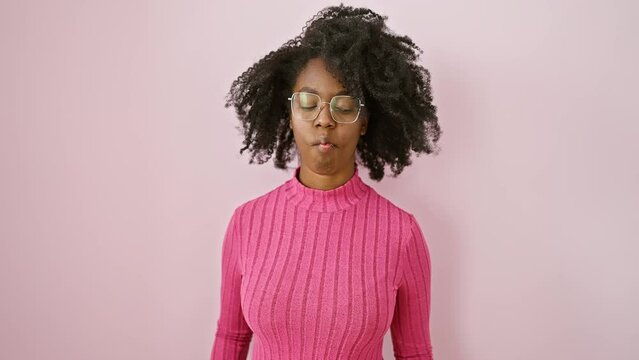 African american woman stands confident making a hilariously funny fish face expression wearing glasses