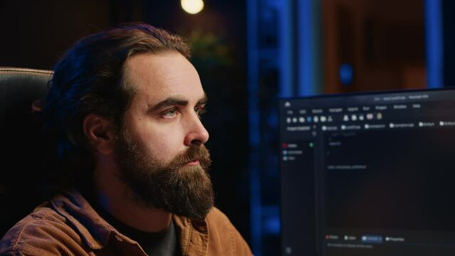 Developer overthinking solutions while doing programming during remote job shift in office while drinking coffee. IT admin enjoying hot beverage working on PC early in the morning, camera A close up