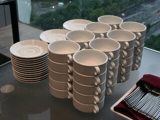 piles of bowls and saucers on the table