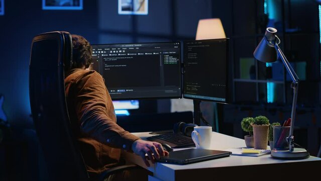 Software designer finishing remote job shift, packing backpack, leaving office after finishing coding project. IT professional putting laptop in bag, sitting up from desk chair, camera A