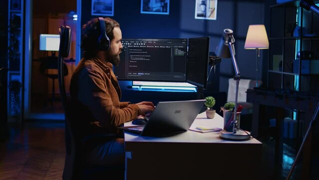 Time lapse of programmer typing complex code in neon lit home office, developing software application. Day in life of teleworking IT specialist doing remote project tasks and programming
