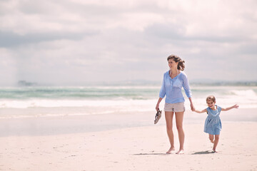 Mother, child and hand holding on beach travel or explore environment or windy summer or holiday, weekend or bonding. Female person, daughter and relax at Australia seaside or peace, vacation or trip