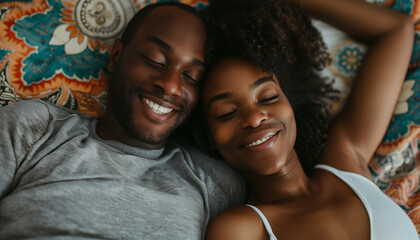 A couple shares a warm, intimate moment, lying closely together with content smiles in a cozy, patterned environment - obrazy, fototapety, plakaty