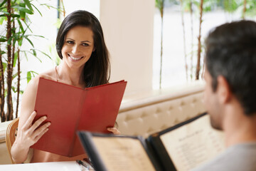 Couple, restaurant and menu for meal selection, conversation and bonding on valentines day. People,...