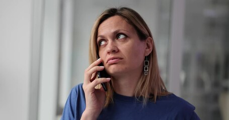 Irritated young woman talking on phone concept