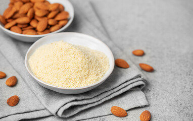 Fresh almond flour in a  bowl and almonds