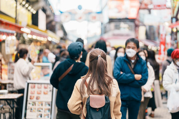 Tourist woman visit Ameyoko market, a busy market street located in Ueno. Landmark and popular for...