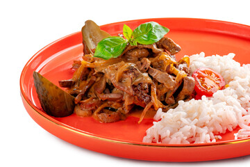 Beef in cream sauce with onions in a red plate with rice on a white background. A dish of beef stroganoff is served decorated, close up