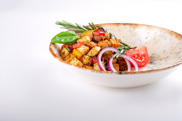 Vegetable Ratatouille with tomatoes, zucchini, pepper and seasonings in a plate on a white...