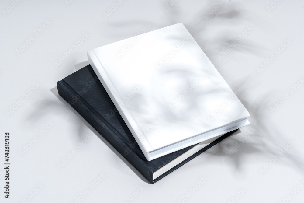 Sticker Black and white hardcover notepads on gray background