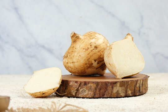 Bengkoang or Jicama Yam on Wooden Board on White Background
