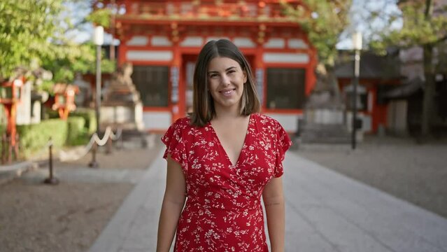 Cheerful beautiful hispanic woman, enjoying the joy of standing smiling at the ancient yasaka temple, kyoto, a casual brunette, emotion shining in her successful, confident expression