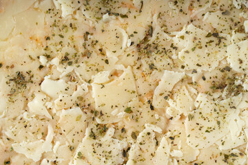 Texture of cheese and spices in raw pizza