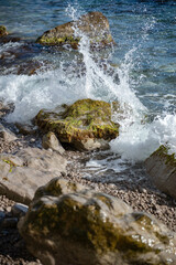 The waves of the sea break on the coastal rocks