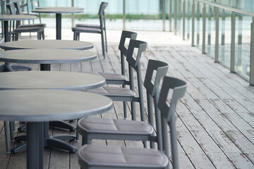 OUTDOOR CAFE TERRACE TABLE AND CHAIRS ON SUNNY DAY