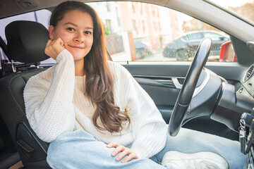 Portrait of young woman inside car interior. The car as a place in which a significant part of people lives passes