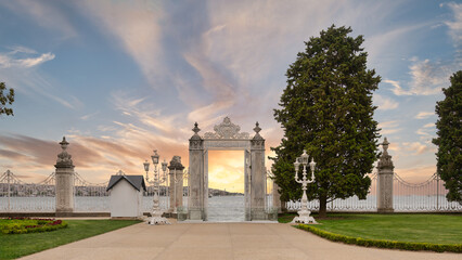 Ornate gates of Dolmabahce Palace open up to a breathtaking sunset over waters of Bosphorus Strait...