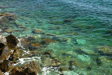 The shoreline of the sea with large stones.
