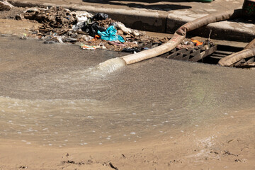 Pumping water after flooding, heavy rainfall, natural disasters pipe, hose pump out the water.