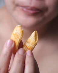 Woman holding crispy cornflakes for eat, It is a popular street food that is delicious and commonly found in Asian