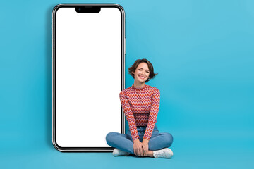 Full length photo of sweet cheerful woman dressed print top chatting modern device empty space isolated blue color background