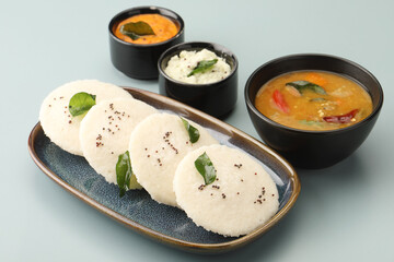 Idly sambar or Idli with Sambhar and green, red chutney. Popular South indian breakfast