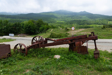 Fototapeta premium An old rusty one-bottomed iron plow for plowing the soil for vineyards.