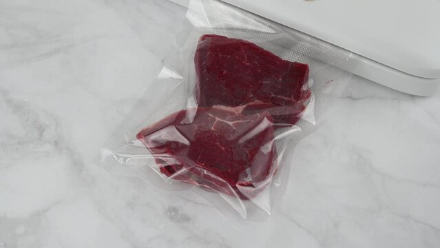 Vacuum packer machine. Vacuums the beef steak. Long-term storage of food products.