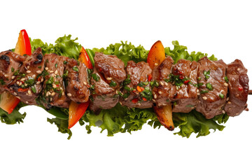 Skewer of Meat and Vegetables on a Bed of Lettuce. A skewer of grilled meat and assorted vegetables served on a bed of fresh lettuce.