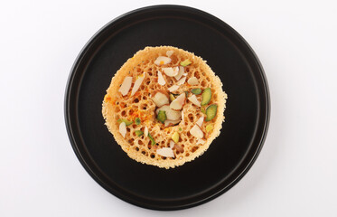 Ghewar made with ghee and flour and soaked in sugar syrup, traditional Rajasthani sweet dish