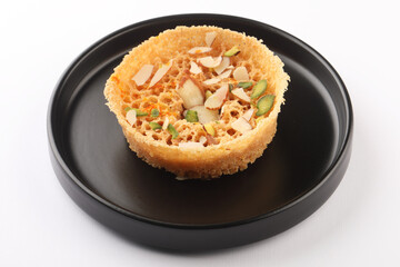 Ghewar made with ghee and flour and soaked in sugar syrup, traditional Rajasthani sweet dish