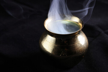 Brass copper metal style pot cauldron smoke vape fog lit inside rising flowing moving rotate on black background