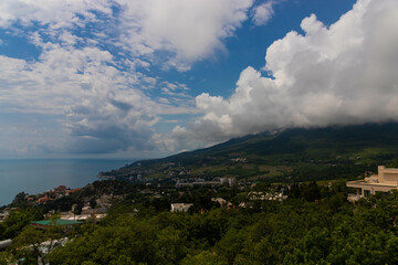 Fototapeta na wymiar Rain clouds over the mountain range and the sea. Scenery