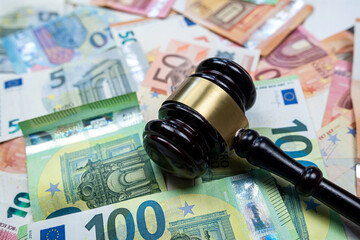 rule of law and auctions with judge's gavel and euro banknotes